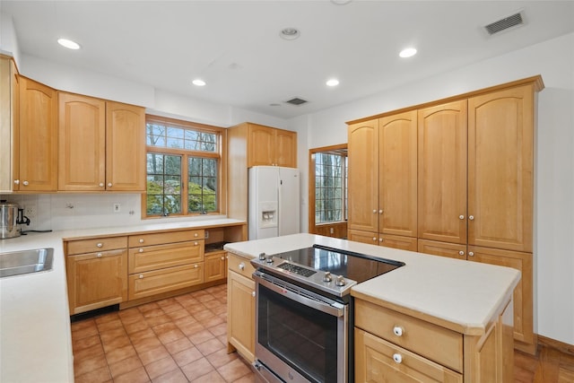 97 Ludlam Rd, Monroe, NY 10950 - kitchen with stainless steel range with electric stovetop, white fridge with ice dispenser, light brown cabinetry, light countertops, and decorative backsplash