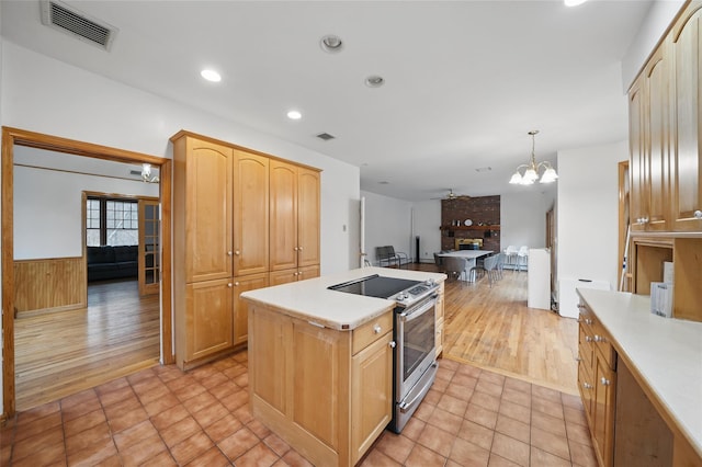 97 Ludlam Rd, Monroe, NY 10950 - kitchen featuring stainless steel electric range, light countertops, a center island, a chandelier, and open floor plan