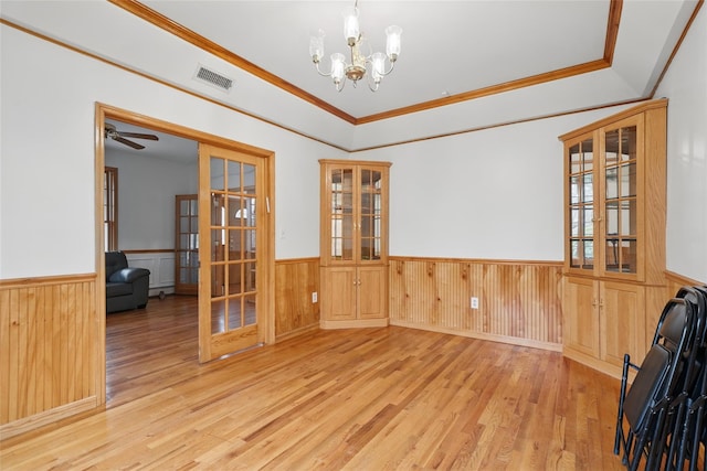97 Ludlam Rd, Monroe, NY 10950 - unfurnished dining area with a wainscoted wall, wood finished floors, french doors, a chandelier, and a tray ceiling