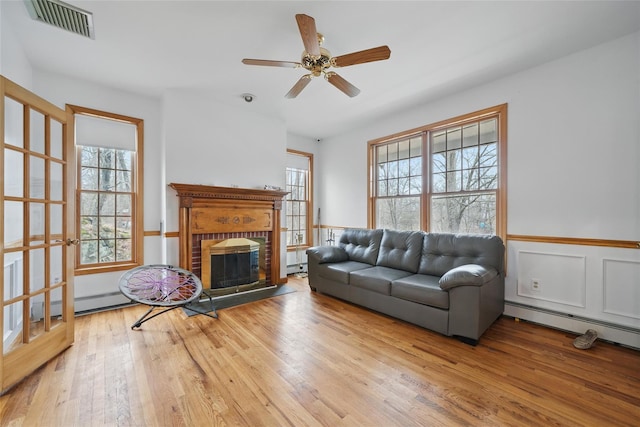 97 Ludlam Rd, Monroe, NY 10950 - living room featuring baseboard heating, wood finished floors, plenty of natural light, and a baseboard radiator