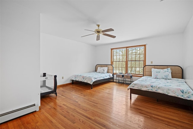 97 Ludlam Rd, Monroe, NY 10950 - bedroom featuring baseboard heating, wood finished floors, ceiling fan, and baseboards