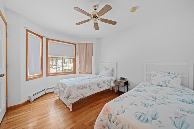 97 Ludlam Rd, Monroe, NY 10950 - bedroom featuring baseboard heating, light wood-type flooring, ceiling fan, and baseboards