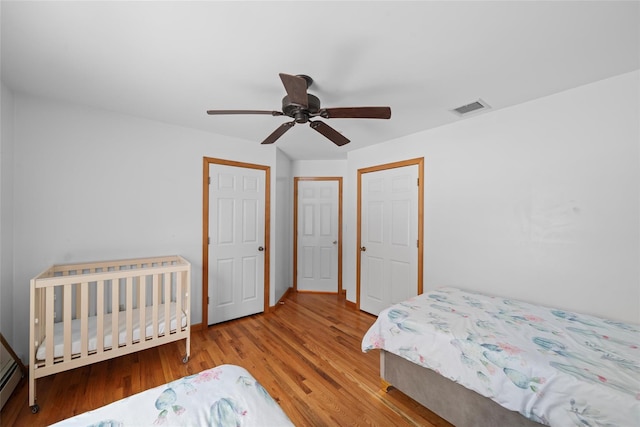 97 Ludlam Rd, Monroe, NY 10950 - bedroom featuring wood finished floors, a baseboard radiator, and ceiling fan