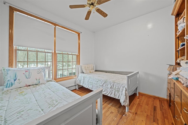97 Ludlam Rd, Monroe, NY 10950 - bedroom with a baseboard radiator, light wood-style floors, baseboards, and a ceiling fan