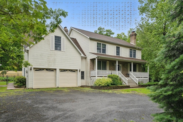 97 Ludlam Rd, Monroe, NY 10950 - view of front facade with a chimney, a porch, a garage, and driveway