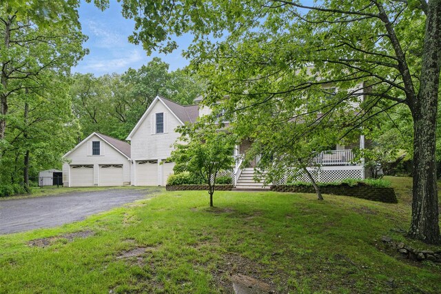 97 Ludlam Rd, Monroe, NY 10950 - view of property hidden behind natural elements with asphalt driveway, a front lawn, and a garage