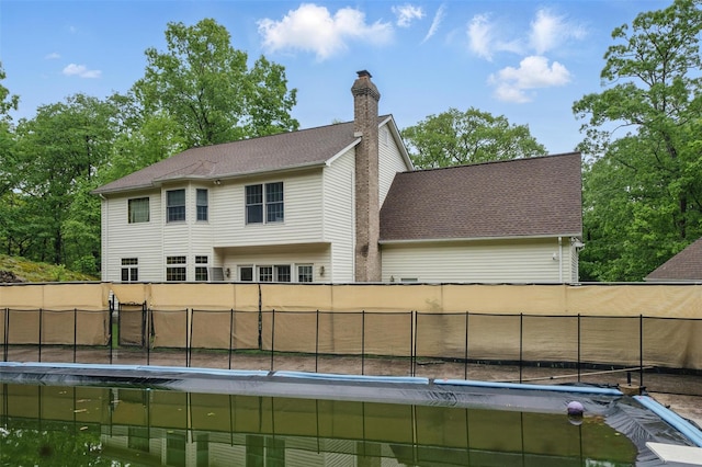 97 Ludlam Rd, Monroe, NY 10950 - rear view of property featuring a chimney and a fenced backyard