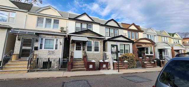 multi unit property featuring stone siding and a residential view