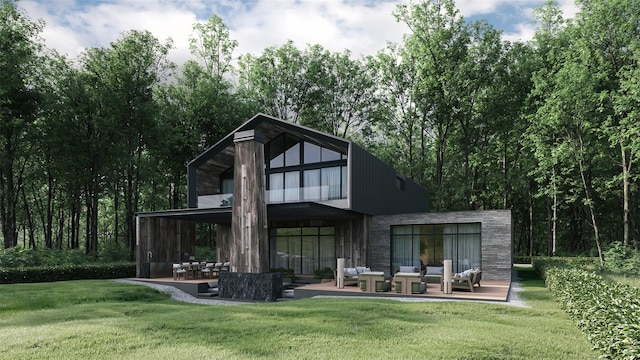 back of house with outdoor lounge area, a lawn, and a patio