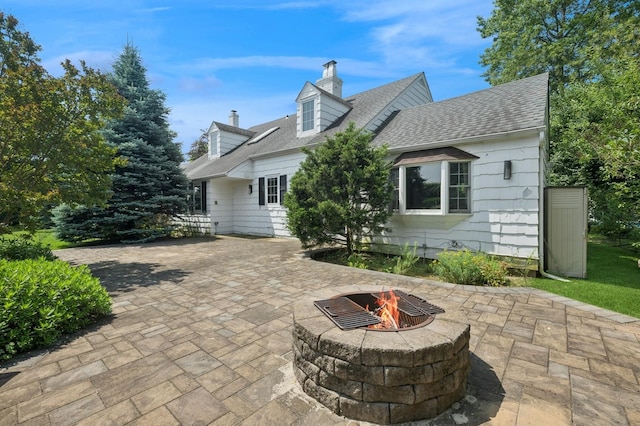 1250 Harbor Rd, Hewlett Harbor, NY 11557 - rear view of house featuring a chimney, a fire pit, a patio, and a shingled roof