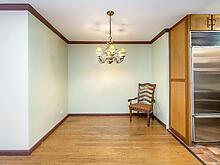 interior space featuring ornamental molding, an inviting chandelier, light wood-style flooring, and baseboards