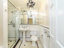 full bathroom featuring a stall shower, tile patterned flooring, and toilet