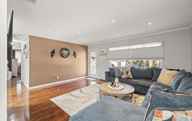 living area featuring ornamental molding, recessed lighting, wood finished floors, and baseboards