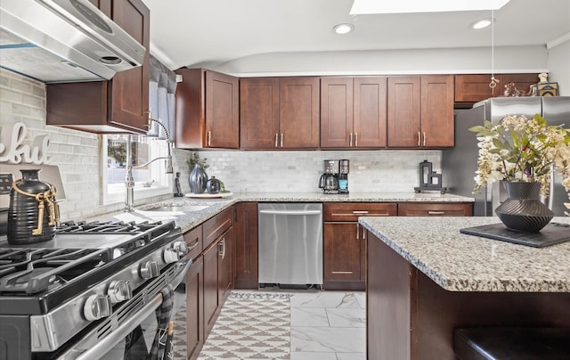 kitchen featuring light stone counters, a skylight, marble finish floor, stainless steel appliances, and under cabinet range hood