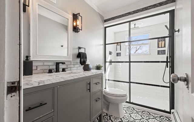 bathroom with toilet, baseboard heating, crown molding, vanity, and a shower stall