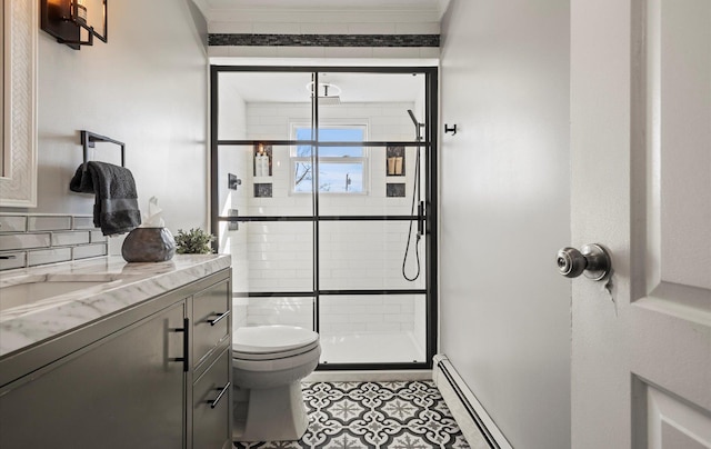 bathroom with a stall shower, decorative backsplash, toilet, a baseboard radiator, and vanity