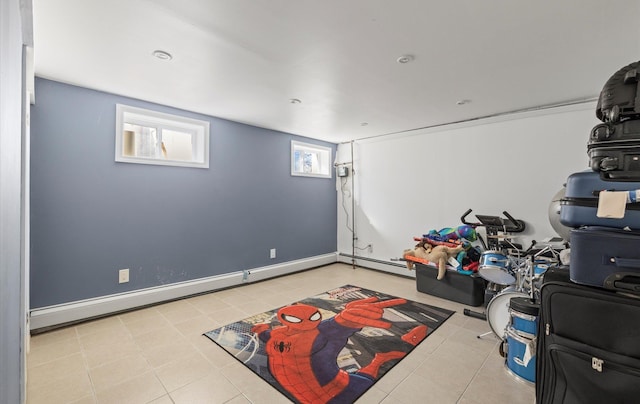 workout area with a baseboard radiator, tile patterned flooring, and baseboards