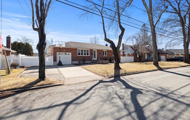 single story home with a garage, concrete driveway, brick siding, and fence