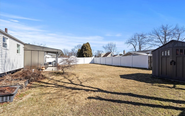 view of yard with an outbuilding, a shed, and a fenced backyard