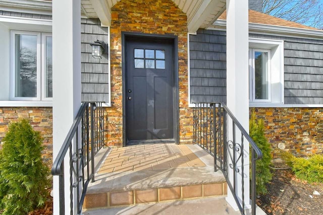 doorway to property featuring stone siding