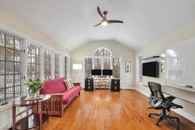 office space featuring vaulted ceiling, wood finished floors, a ceiling fan, and baseboards