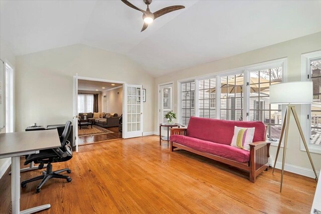 office featuring lofted ceiling, ceiling fan, wood finished floors, baseboards, and french doors