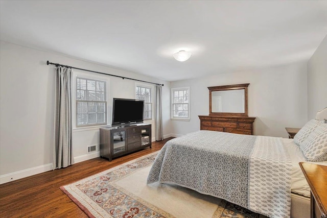 bedroom featuring dark wood-style flooring, visible vents, and baseboards