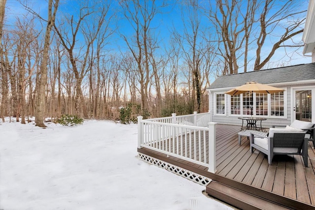 snow covered deck featuring outdoor dining space