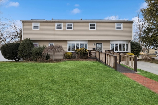 rear view of house featuring a yard