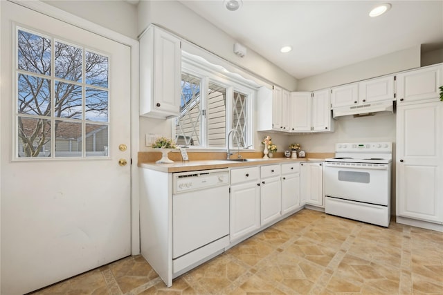 kitchen featuring white appliances, light countertops, under cabinet range hood, white cabinetry, and a sink