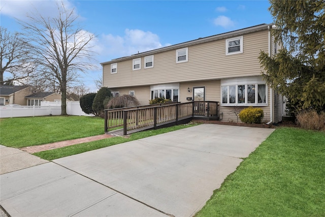 view of front facade with a front yard, a patio area, and fence