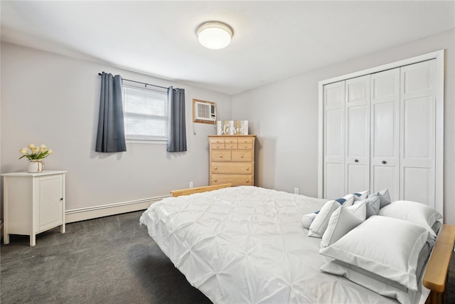 bedroom with a baseboard heating unit, dark colored carpet, a closet, and a wall mounted AC