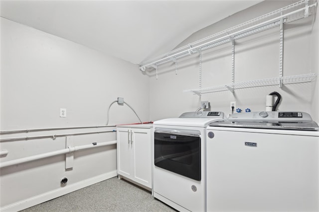 laundry area with cabinet space, baseboards, and washer and dryer