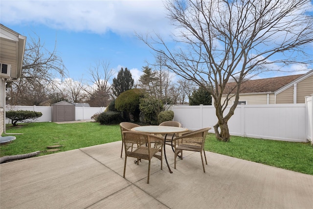 view of patio with a storage shed, outdoor dining area, an outdoor structure, and a fenced backyard