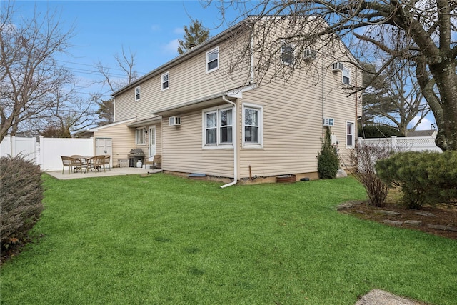 back of house featuring a patio, a lawn, and fence