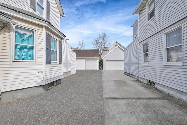 view of home's exterior featuring an outdoor structure and a detached garage