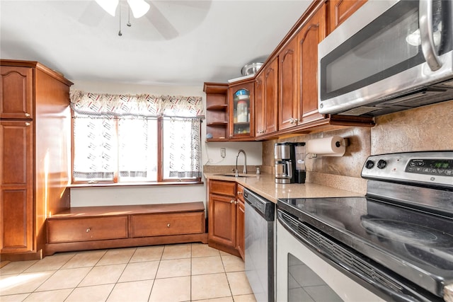 kitchen featuring appliances with stainless steel finishes, brown cabinets, and a sink