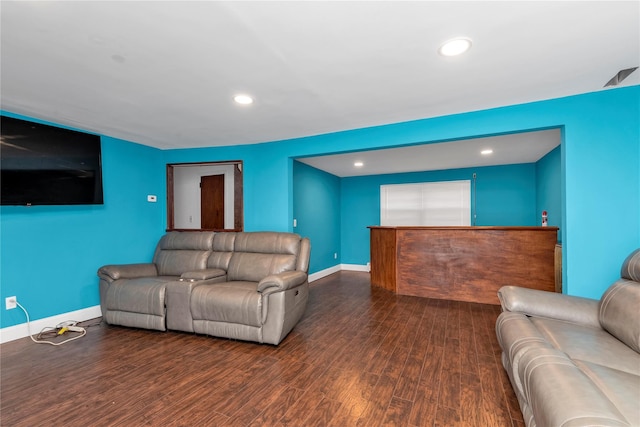 living room featuring baseboards, dark wood-type flooring, and recessed lighting