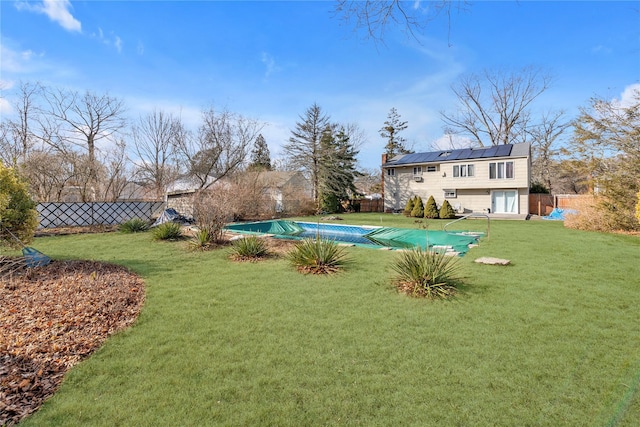 view of yard with fence and a fenced in pool