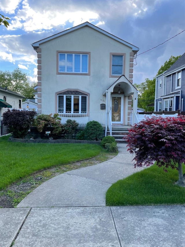 view of front of property with a front lawn and stucco siding