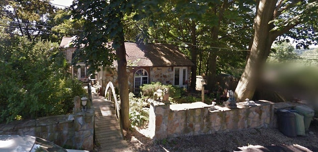 view of side of home with stone siding