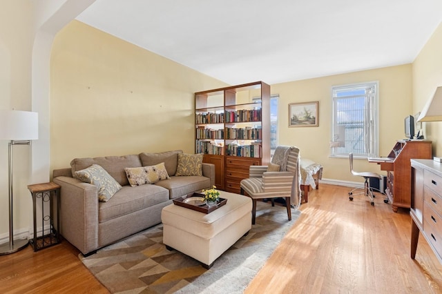 living room featuring light wood-type flooring and baseboards