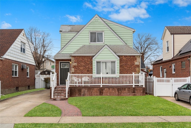 bungalow with brick siding, roof with shingles, a gate, a porch, and a front yard