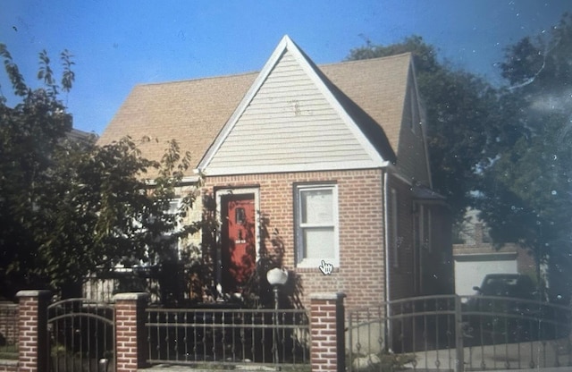 view of front facade with fence and brick siding