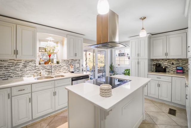 kitchen with a sink, island exhaust hood, pendant lighting, and light countertops