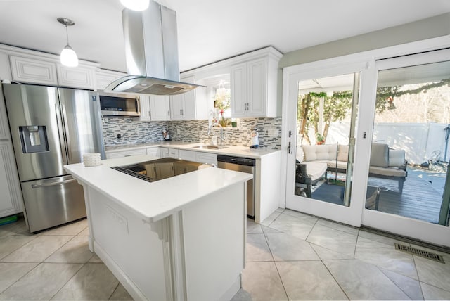 kitchen with stainless steel appliances, island exhaust hood, light countertops, and white cabinets