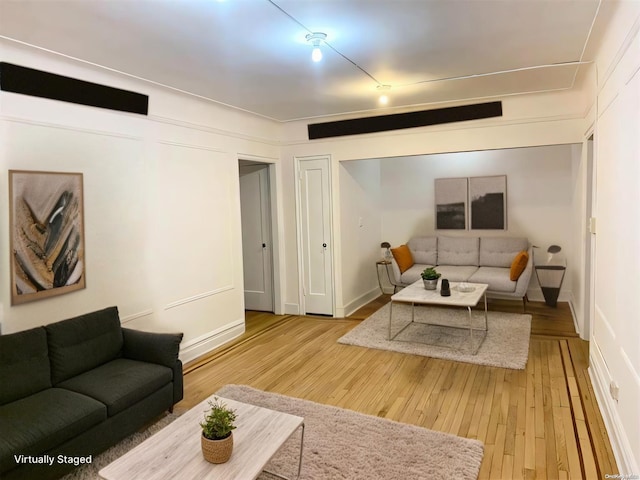 living room featuring baseboards and wood finished floors