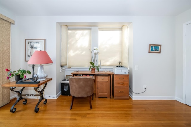office featuring light wood-style flooring and baseboards