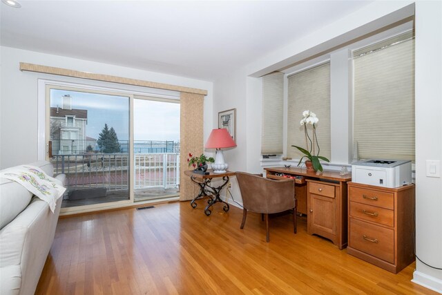 office space featuring light wood-style floors and visible vents