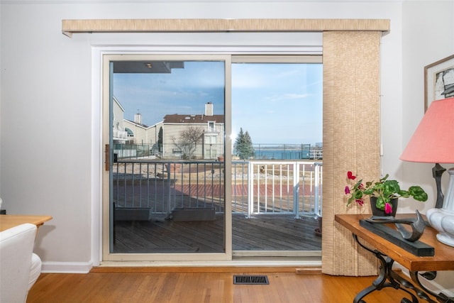 entryway featuring wood finished floors, visible vents, and baseboards
